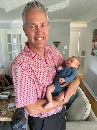 Dr. Rudd holding his first granddaughter